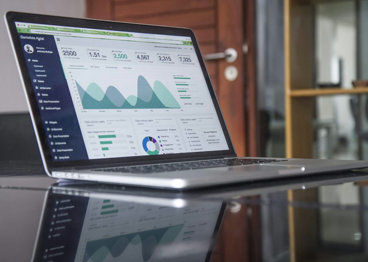A laptop displaying an analytics dashboard on a desk
